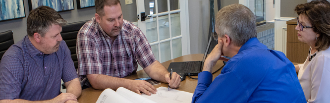 Paul Logemann and Jason Troshynski working with homeowners on their custom home plans
